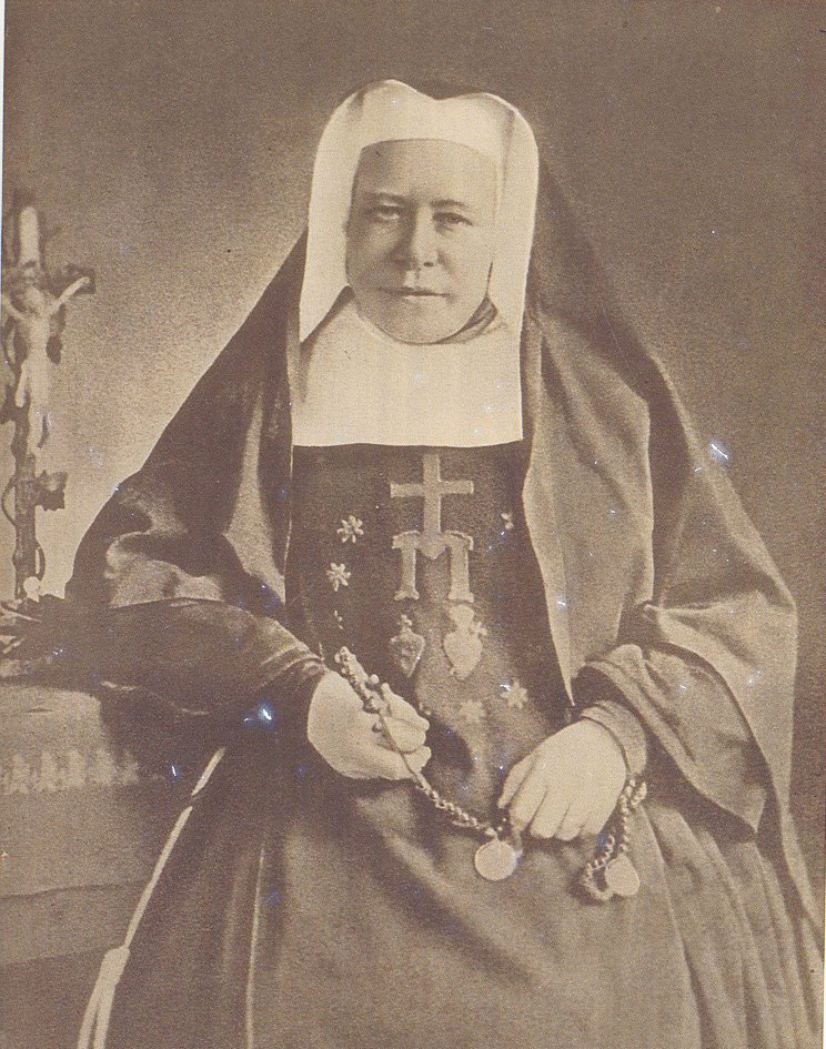 A sepia-tinted photograph of Mother Clara Pfaender shows her in full habit, holding a rosary.